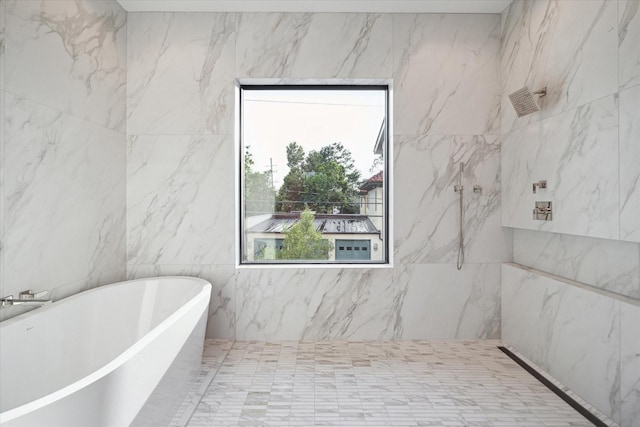 bathroom featuring shower with separate bathtub