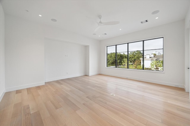 spare room featuring light hardwood / wood-style floors and ceiling fan