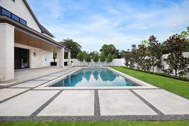 view of pool featuring a yard and a patio area