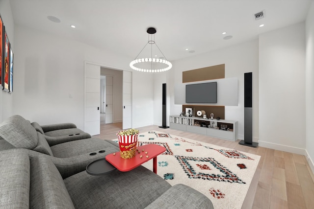 living room featuring a chandelier and light hardwood / wood-style floors