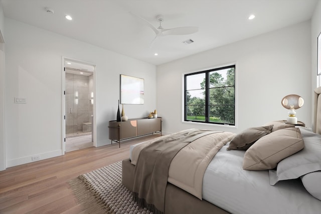 bedroom with ensuite bath, light hardwood / wood-style floors, and ceiling fan