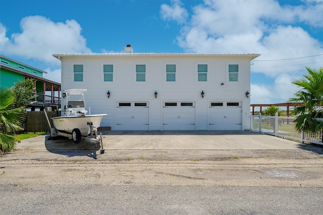 exterior space with a garage, a chimney, and fence