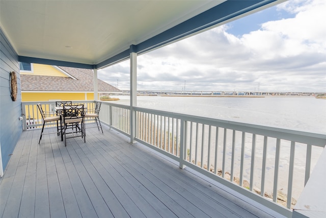 wooden deck with a water view