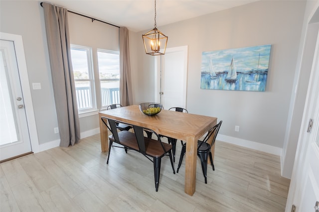 dining area with a chandelier and light wood-type flooring