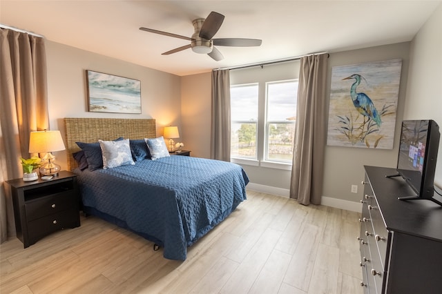 bedroom with ceiling fan and light hardwood / wood-style floors