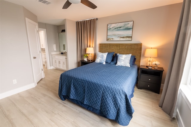 bedroom with ceiling fan, connected bathroom, and light wood-type flooring