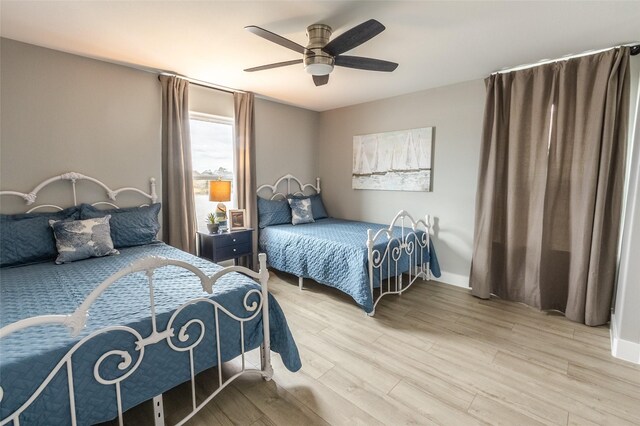 bedroom with light hardwood / wood-style floors and ceiling fan