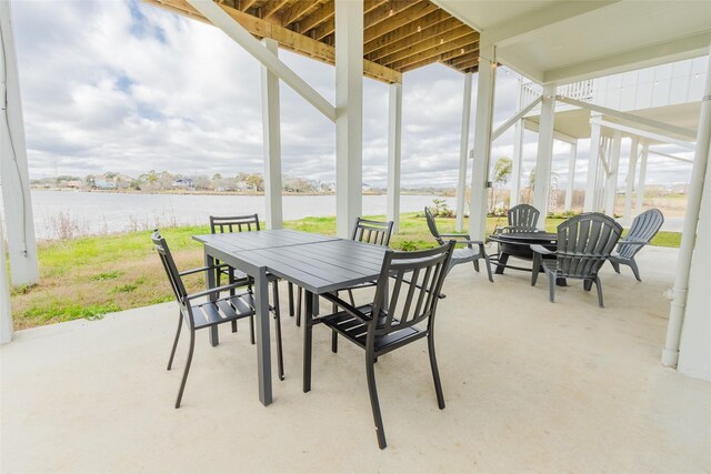 sunroom featuring a water view