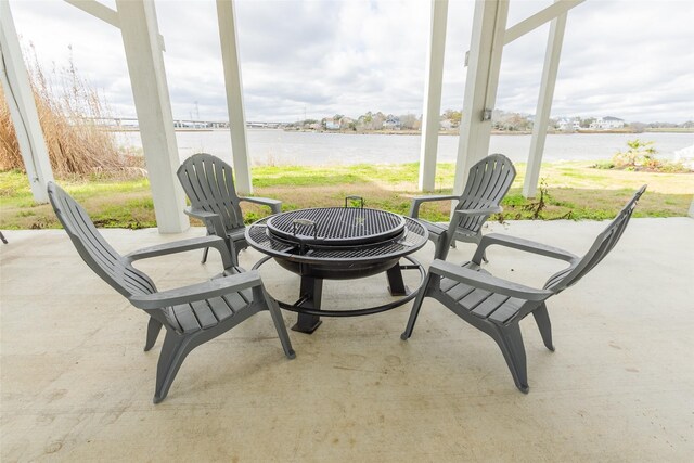 sunroom featuring a water view