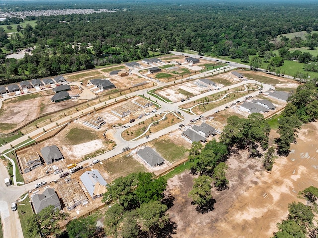 birds eye view of property featuring a view of trees