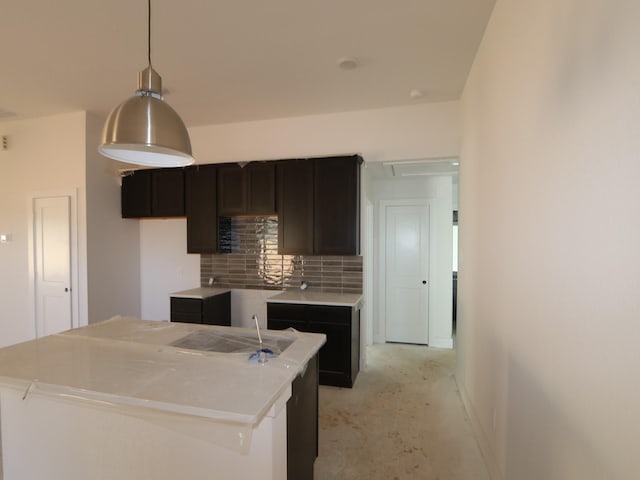 kitchen featuring pendant lighting, backsplash, and a center island