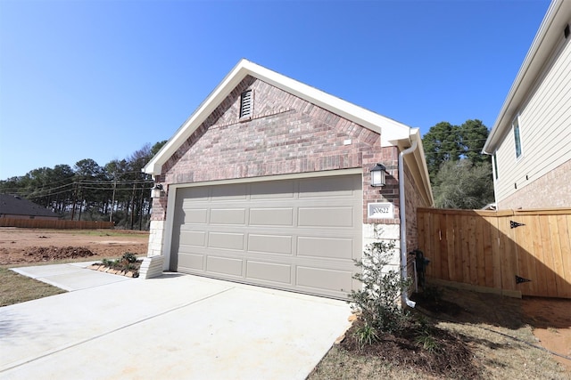 view of property exterior featuring an outbuilding, brick siding, and fence