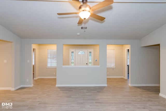 unfurnished living room with ceiling fan and light hardwood / wood-style flooring