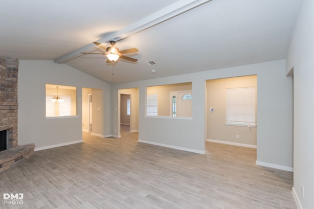 unfurnished living room with vaulted ceiling with beams, a brick fireplace, ceiling fan with notable chandelier, and light hardwood / wood-style flooring