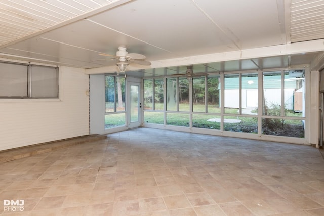 unfurnished sunroom with ceiling fan