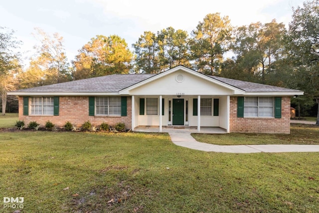 single story home with covered porch and a front lawn