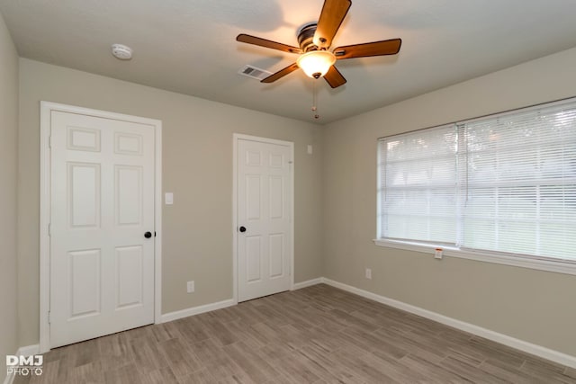 unfurnished bedroom featuring ceiling fan and light hardwood / wood-style floors