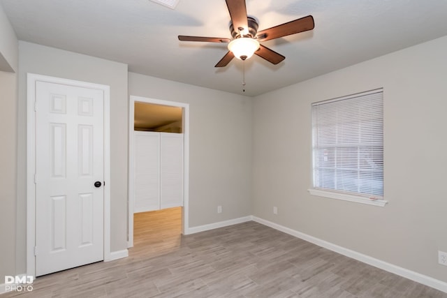 unfurnished bedroom with ceiling fan and light hardwood / wood-style flooring