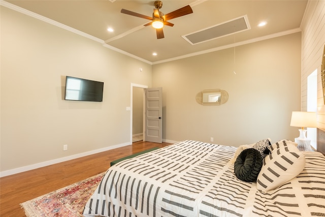 bedroom with ceiling fan, wood-type flooring, and ornamental molding