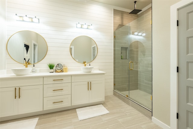 bathroom with vanity, a shower with door, and wooden walls