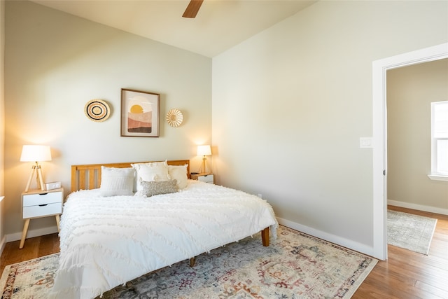 bedroom with wood-type flooring, vaulted ceiling, and ceiling fan