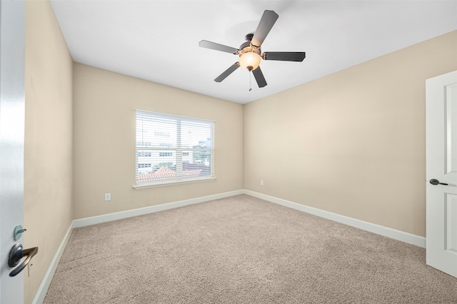 carpeted empty room featuring ceiling fan