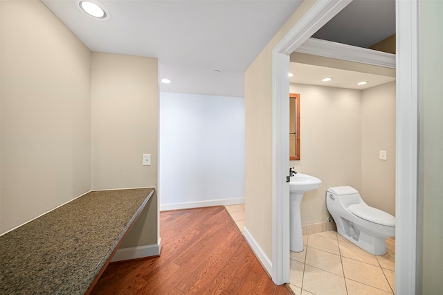 bathroom with hardwood / wood-style floors and toilet