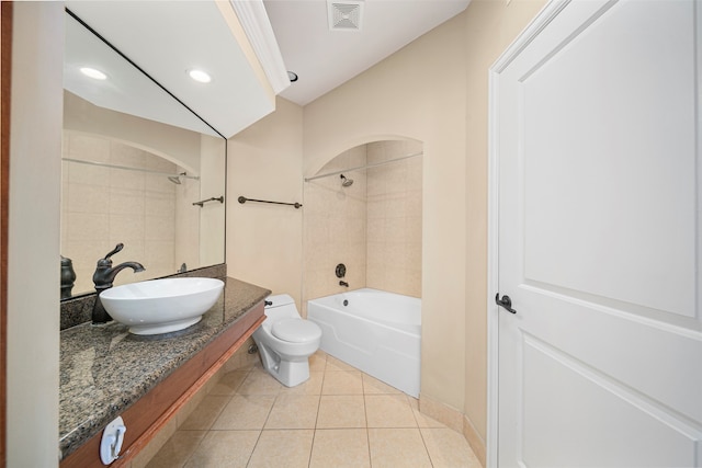 full bathroom with tiled shower / bath, vanity, toilet, and tile flooring