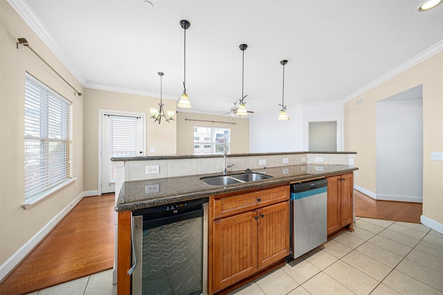 kitchen with stainless steel dishwasher, dishwasher, light tile flooring, backsplash, and sink