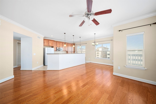 unfurnished living room featuring ceiling fan with notable chandelier, light tile floors, and ornamental molding