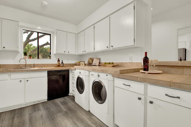 laundry room featuring washer and clothes dryer, sink, and hardwood / wood-style flooring