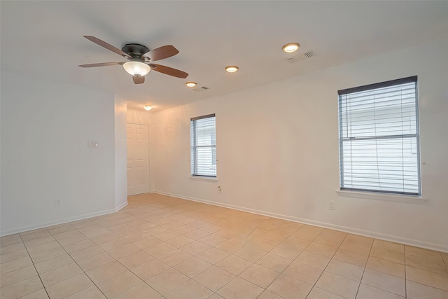 spare room with light tile patterned floors and ceiling fan