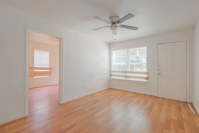 empty room featuring ceiling fan and light hardwood / wood-style flooring