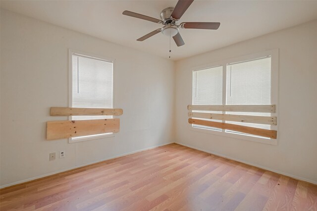 empty room with light hardwood / wood-style flooring and ceiling fan