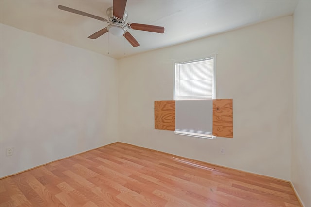 empty room with ceiling fan and light hardwood / wood-style floors