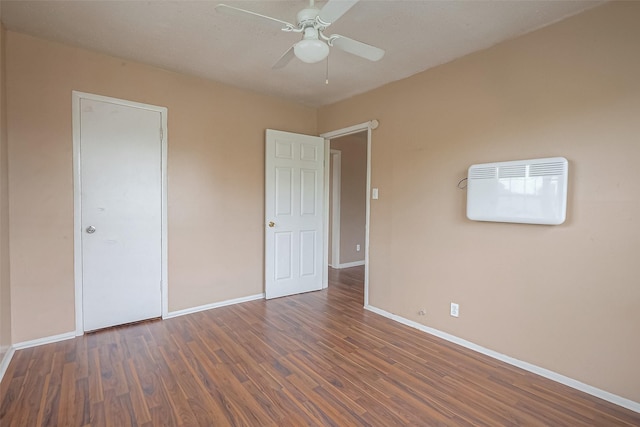 unfurnished bedroom featuring ceiling fan and dark wood-type flooring