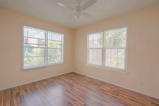 spare room featuring a textured ceiling, hardwood / wood-style flooring, and ceiling fan