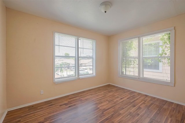 empty room featuring hardwood / wood-style floors and a healthy amount of sunlight