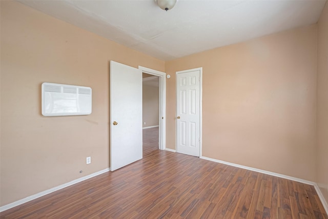 unfurnished room with hardwood / wood-style flooring