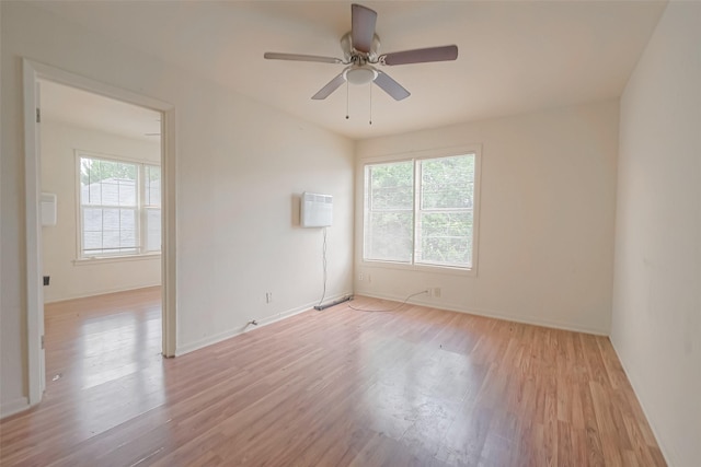 spare room with ceiling fan and light wood-type flooring