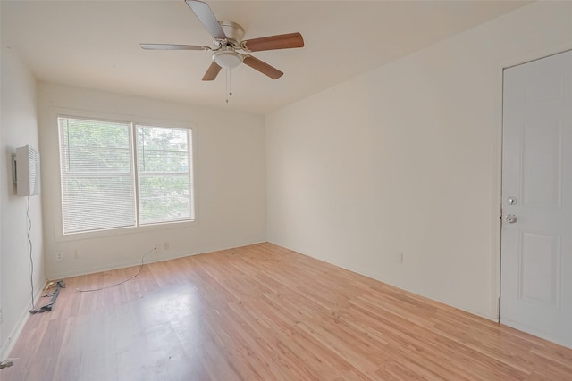 empty room with ceiling fan and light hardwood / wood-style floors