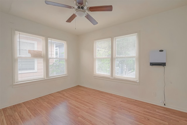 empty room featuring ceiling fan and light hardwood / wood-style flooring