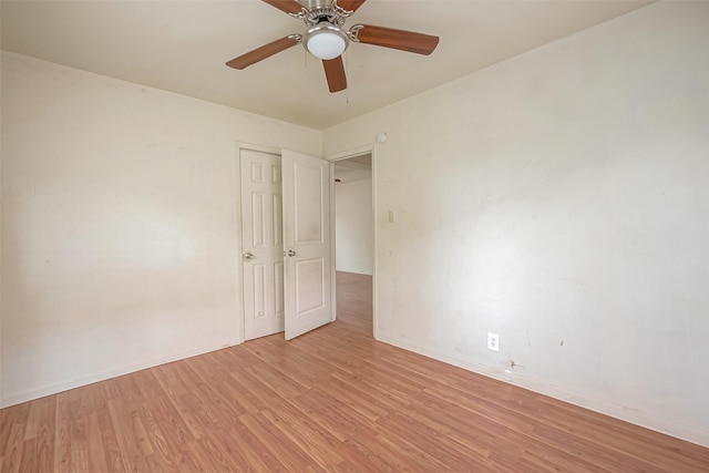 unfurnished room featuring ceiling fan and light wood-type flooring