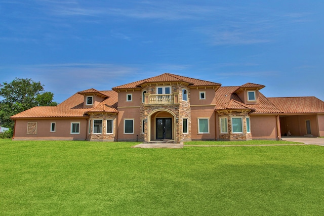 17018 Grant Rd, Cypress, TX 77429 - mediterranean / spanish house featuring stone siding, stucco siding, a tiled roof, and a front lawn