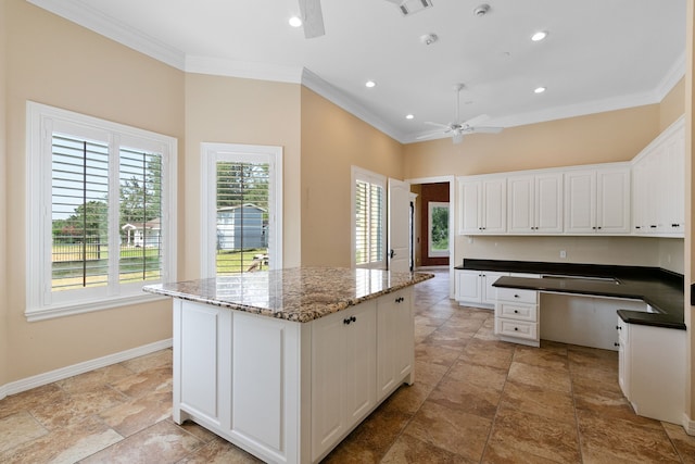 17018 Grant Rd, Cypress, TX 77429 - kitchen with a ceiling fan, crown molding, a kitchen island, healthy amount of natural light, and baseboards