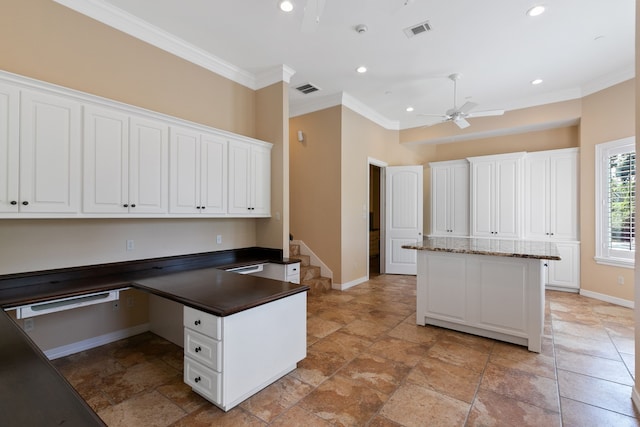 17018 Grant Rd, Cypress, TX 77429 - kitchen with ornamental molding, baseboards, a peninsula, a ceiling fan, and white cabinetry