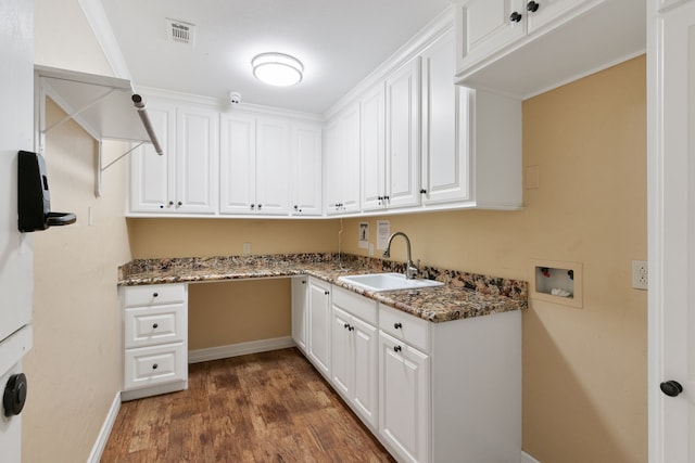 laundry room featuring cabinets, dark wood-type flooring, washer hookup, ornamental molding, and sink