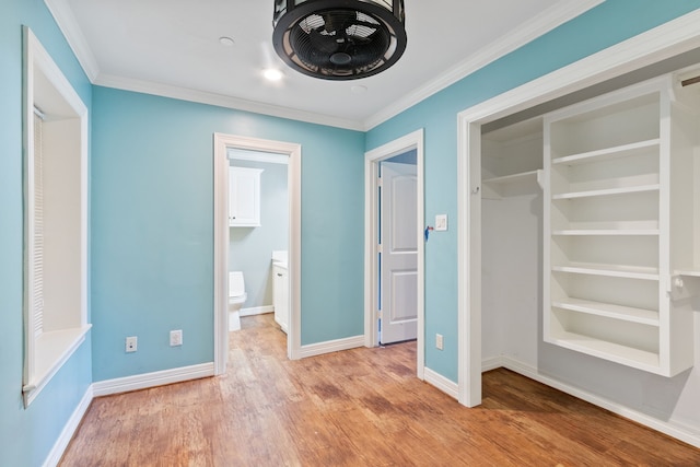 unfurnished bedroom with ornamental molding and hardwood / wood-style floors