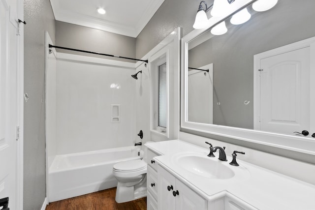 full bathroom featuring toilet, hardwood / wood-style floors, ornamental molding, bathtub / shower combination, and vanity