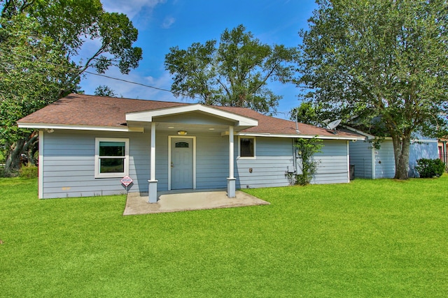 17018 Grant Rd, Cypress, TX 77429 - rear view of property featuring a yard, roof with shingles, and a patio